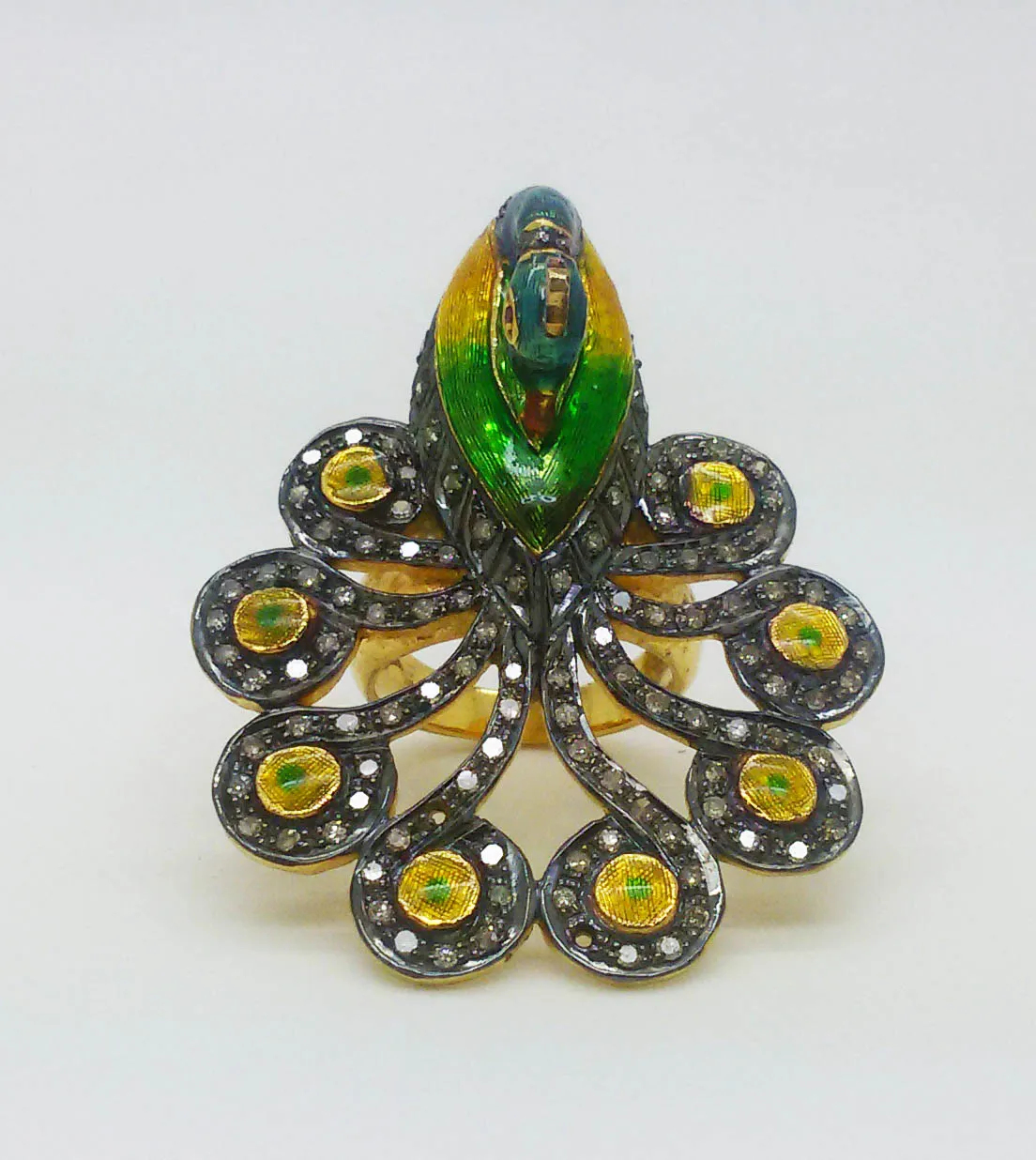 Peacock plume ring from above: multicolour enamel peacock with a fanned tail of stone-set plumes