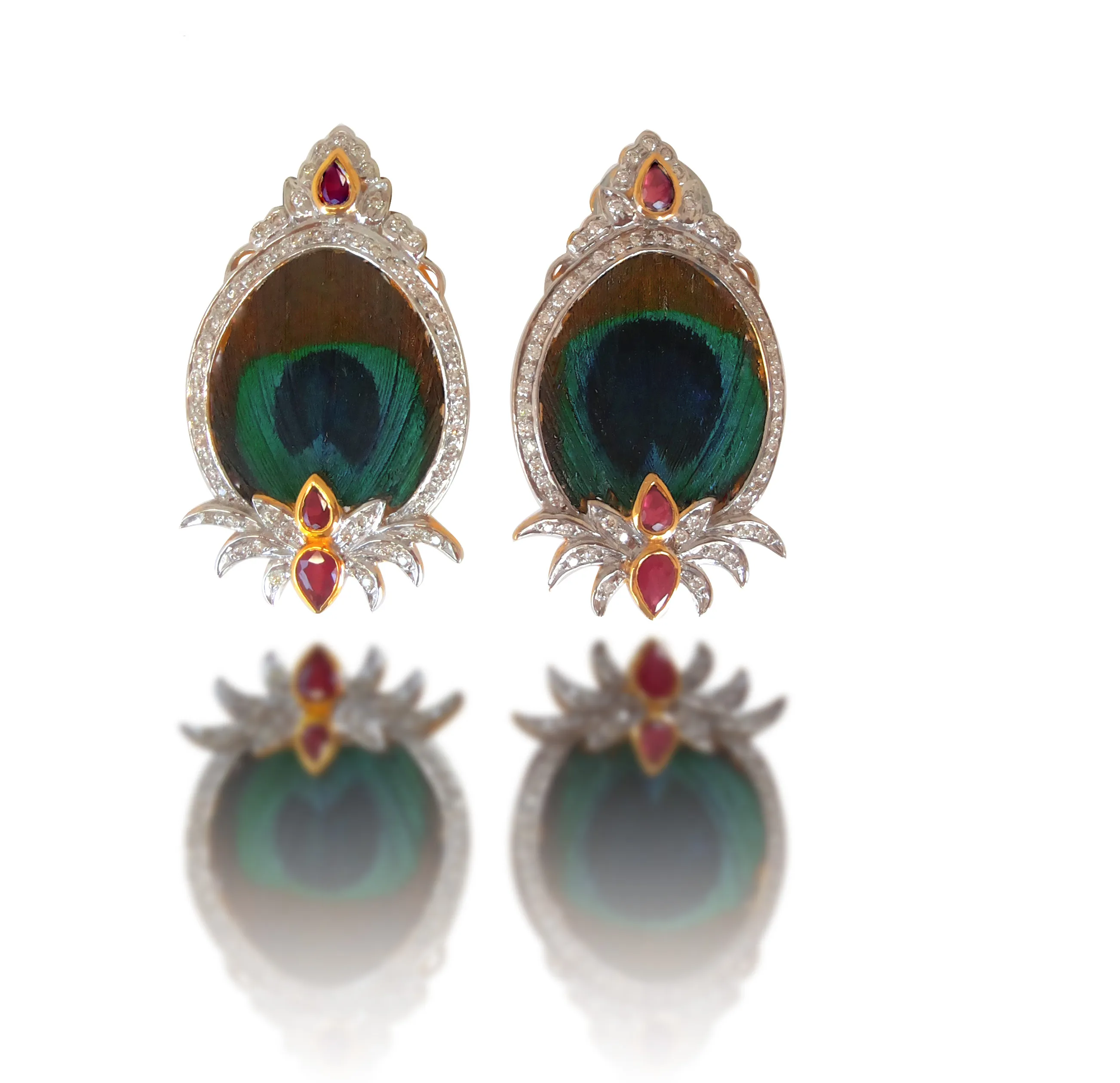 Teardrop medallion earrings framing peacock-feather eyes in diamond-set borders