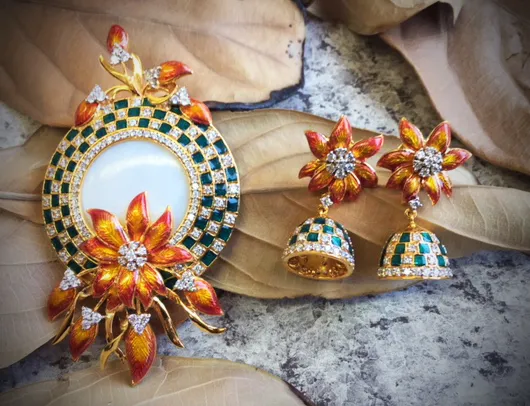 Round pendant with orange enamel flowers and diamond clusters, with matching jhumki earrings